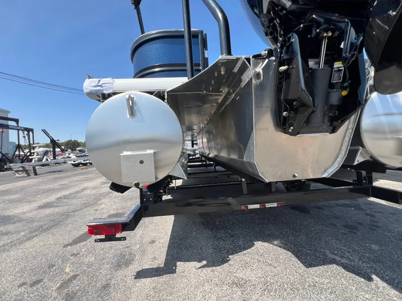 Slide: The Image of 2025 Premier 220 Sunscape pontoon boat on trailer, rear view, outdoor setting. - 11