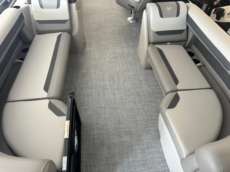 Slide: The Image of 2025 Premier 220 Sunscape boat interior with gray seating and carpet flooring. - 16