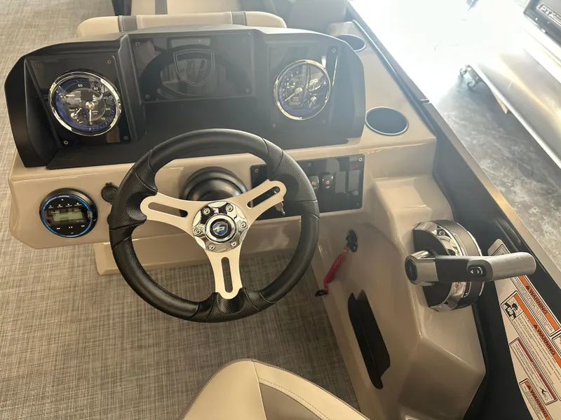Slide: The Image of 2025 Premier 220 Sunscape boat dashboard with steering wheel and controls. - 17