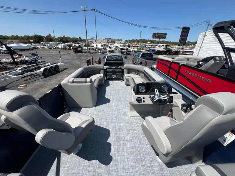Slide: The Image of 2025 Premier 220 Sunscape pontoon boat interior with modern seating and dashboard. - 6