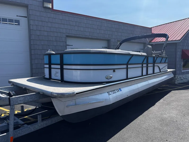 Slide: The Image of 2020 Misty Harbor 2585 Biscayne Bay CE pontoon boat on trailer, parked outside. - 1