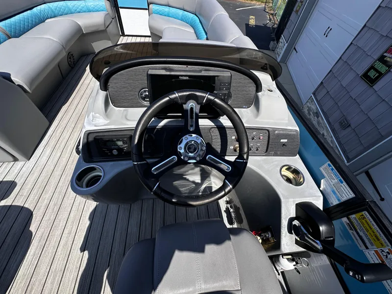 Slide: The Image of 2020 Misty Harbor 2585 Biscayne Bay CE boat dashboard with steering wheel and controls. - 13
