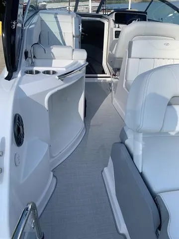 Slide: The Image of 2025 Regal 28 Express boat interior with white seating and modern amenities. - 10