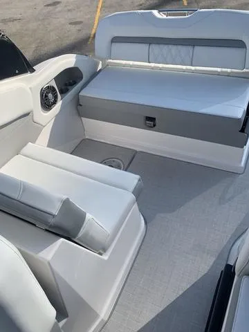 Slide: The Image of 2025 Regal 28 Express boat interior with white seating and modern design. - 11