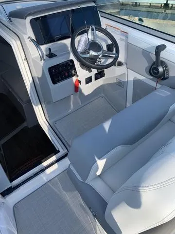 Slide: The Image of 2025 Regal 28 Express boat cockpit with modern steering and controls. - 12