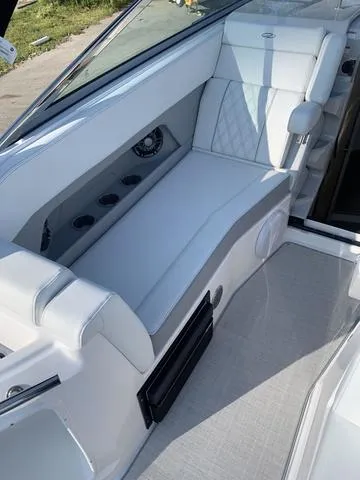 Slide: The Image of 2025 Regal 28 Express boat interior with white seating and modern design. - 13