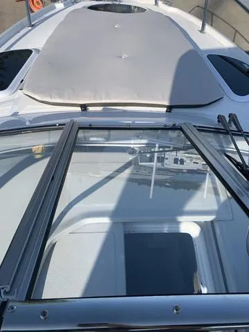 Slide: The Image of 2025 Regal 28 Express boat deck with sunroof and sleek design. - 15