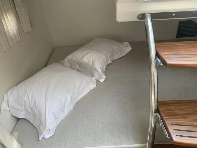 Slide: The Image of Cozy cabin interior of 2025 Regal 28 Express with bed and pillows. - 16