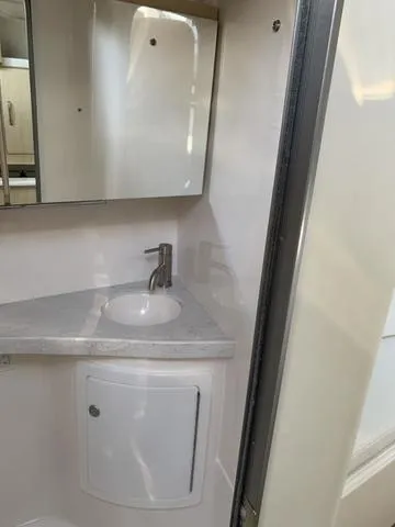 Slide: The Image of 2025 Regal 28 Express boat bathroom with modern sink and mirror. - 20