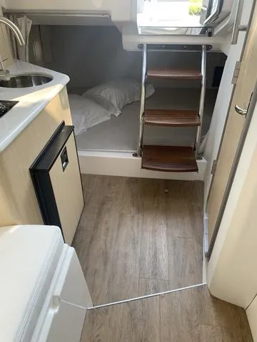 Slide: The Image of 2025 Regal 28 Express cabin interior with wooden steps and modern amenities. - 21