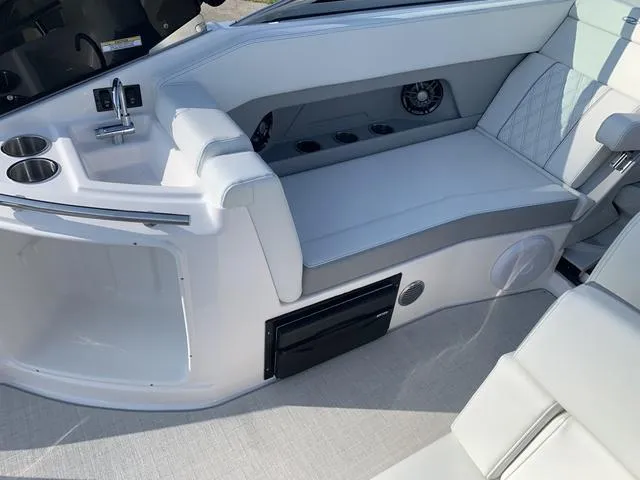 Slide: The Image of 2025 Regal 28 Express boat interior with seating, sink, and cup holders. - 22