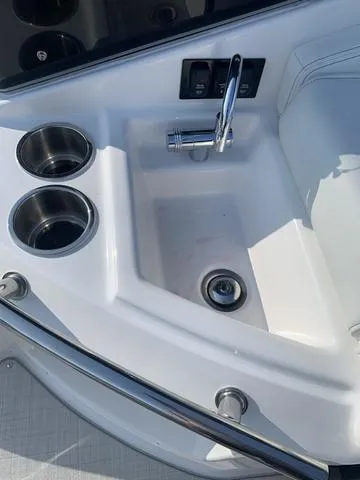 Slide: The Image of 2025 Regal 28 Express boat sink with cup holders and faucet. - 23
