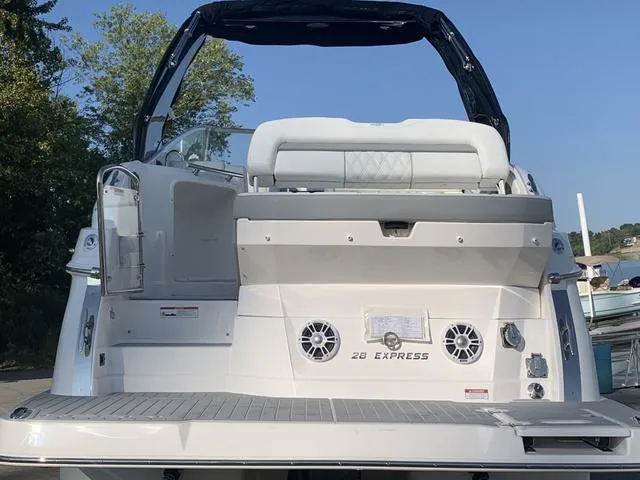 Slide: The Image of 2025 Regal 28 Express boat, rear view, featuring spacious deck and modern design. - 4