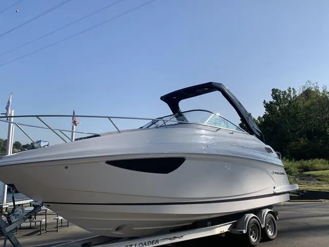 Slide: The Image of 2025 Regal 28 Express boat on trailer, sleek design, sunny day. - 5