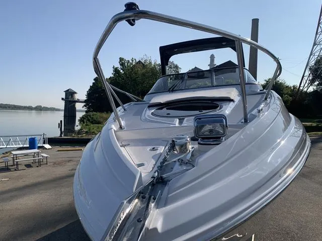 Slide: The Image of 2025 Regal 28 Express boat docked by a serene riverside. - 6