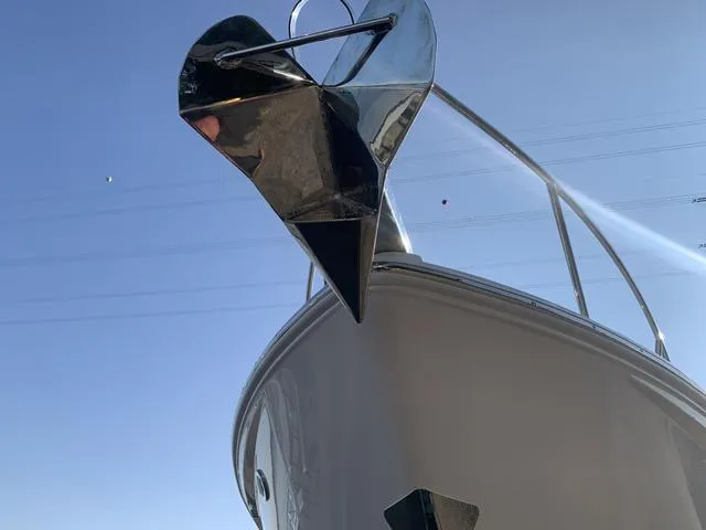 Slide: The Image of 2025 Regal 28 Express boat with a shiny anchor against a clear blue sky. - 7