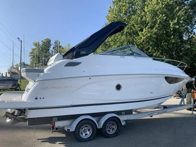 Slide: The Image of 2025 Regal 28 Express boat on trailer, sleek design, white exterior. - 8