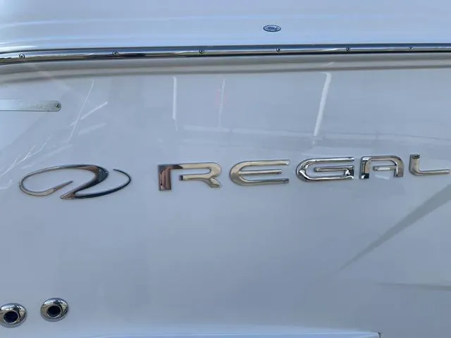 Slide: The Image of 2025 Regal 28 Express boat logo on white hull. - 9