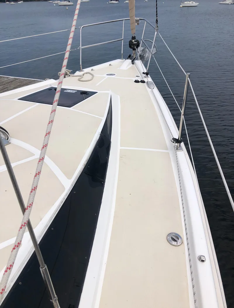 Slide: The Image of 2016 Marlow-Hunter 37 sailboat deck with railing, docked on calm water. - 17