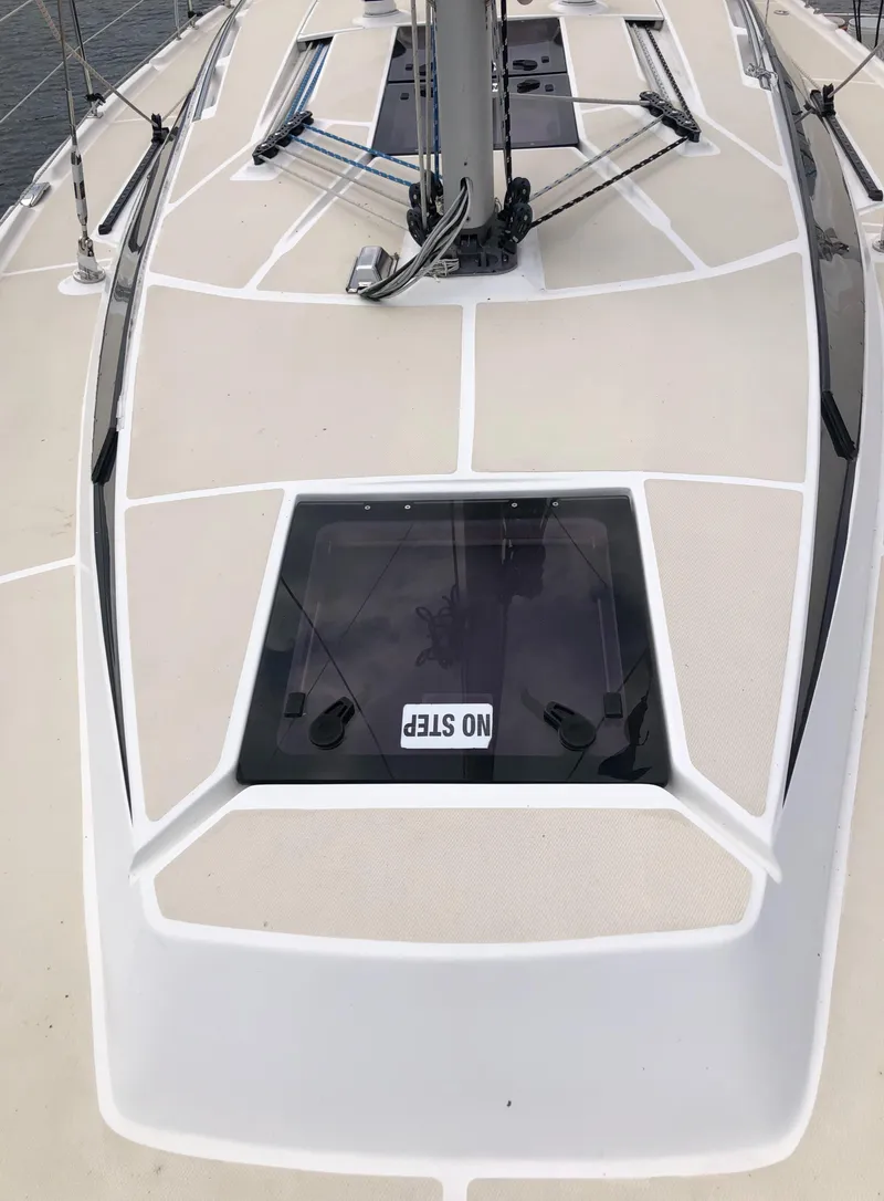 Slide: The Image of 2016 Marlow-Hunter 37 sailboat deck with "No Step" sign on hatch. - 18