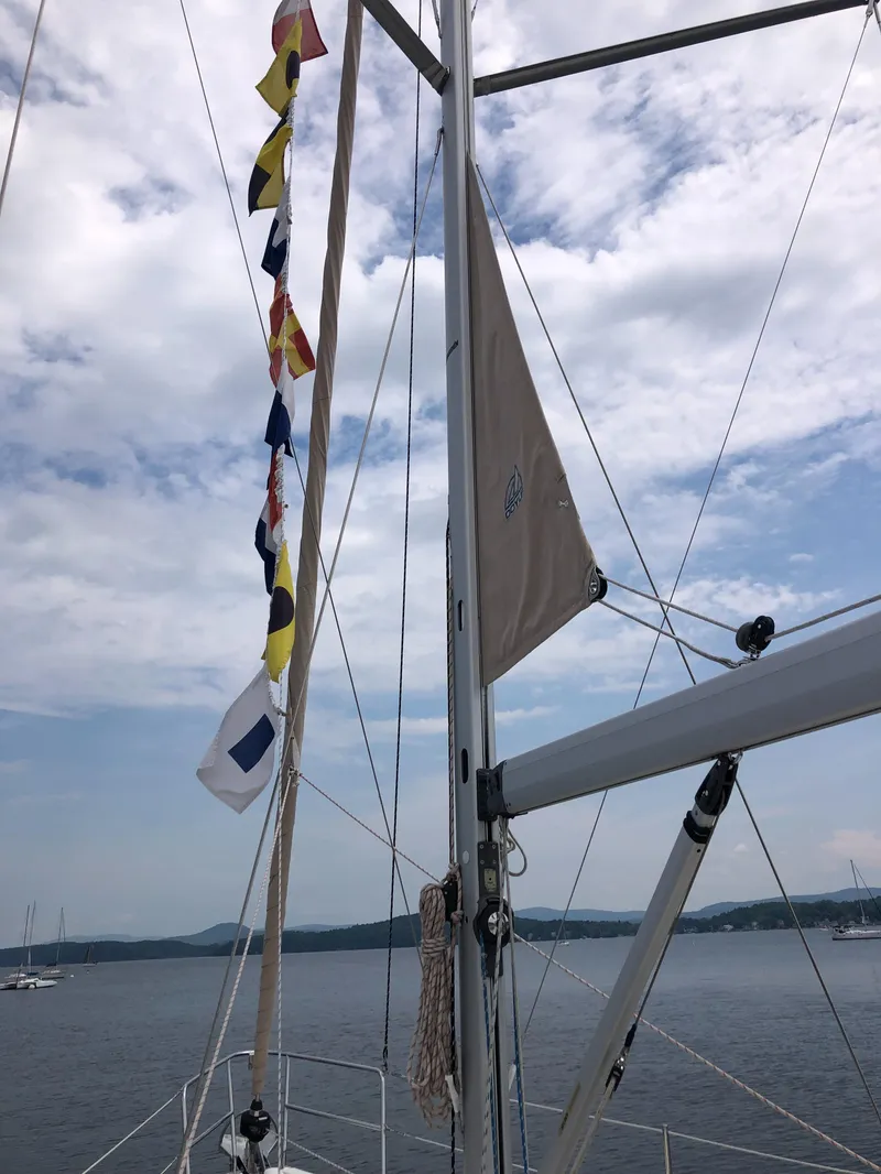 Slide: The Image of Sailboat mast with colorful flags, Marlow-Hunter 37, 2016 model, under a cloudy sky. - 20