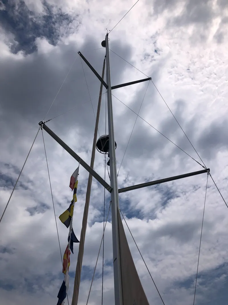 Slide: The Image of Marlow-Hunter 37 sailboat mast with flags against cloudy sky, 2016 model. - 21
