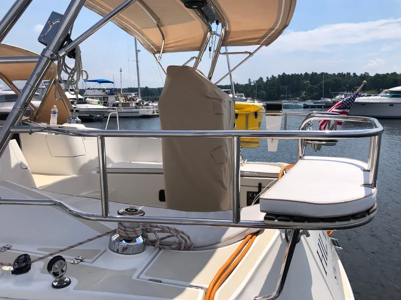 Slide: The Image of 2016 Marlow-Hunter 37 sailboat deck with seating, docked in a marina. - 27