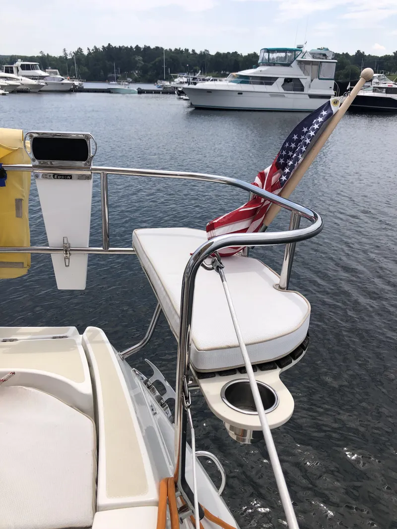 Slide: The Image of 2016 Marlow-Hunter 37 sailboat stern with American flag, docked in a marina. - 28