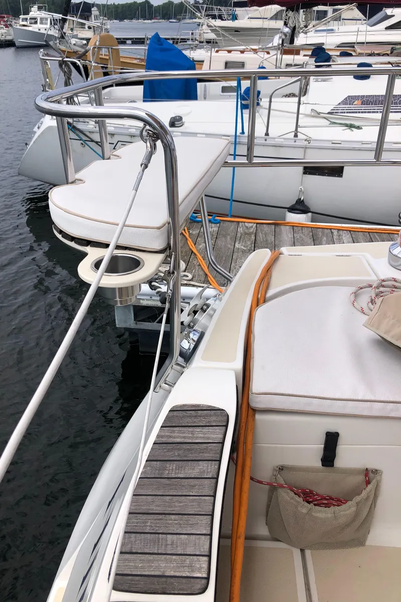 Slide: The Image of 2016 Marlow-Hunter 37 sailboat docked at marina, featuring deck and seating area. - 30