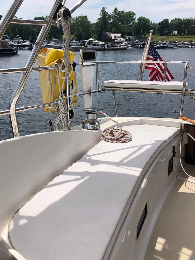 Slide: The Image of 2016 Marlow-Hunter 37 sailboat deck with American flag, docked at marina. - 35