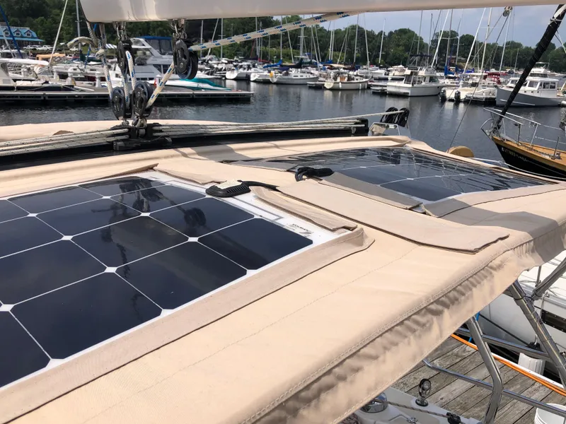 Slide: The Image of 2016 Marlow-Hunter 37 sailboat with solar panels docked at a marina. - 38