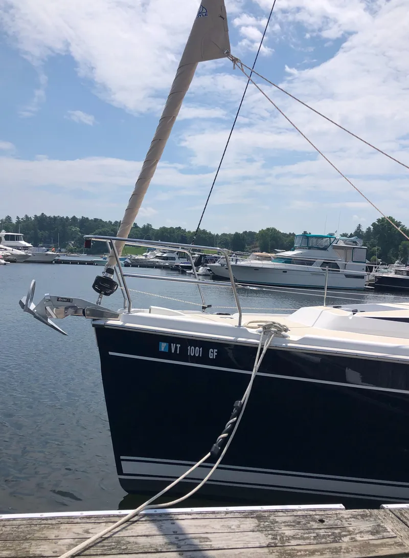 Slide: The Image of 2016 Marlow-Hunter 37 sailboat docked at a marina under a partly cloudy sky. - 4