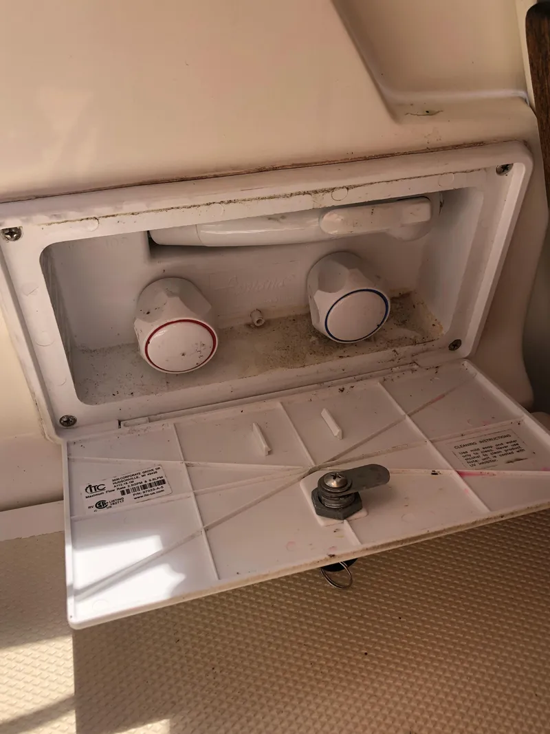 Slide: The Image of Marlow-Hunter 37 (2016) boat control panel with open hatch and knobs. - 43