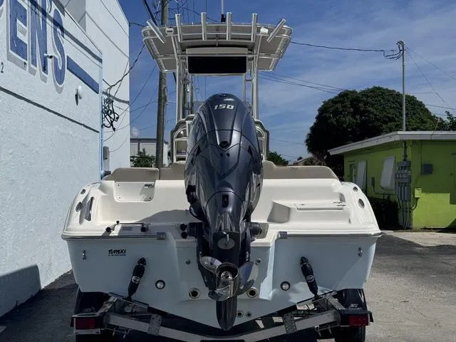 Slide: The Image of 2025 Key West 219 FS boat with powerful outboard motor, parked outdoors. - 3