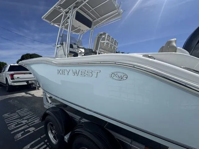 Slide: The Image of 2025 Key West 219 FS boat on trailer, side view under clear blue sky. - 5
