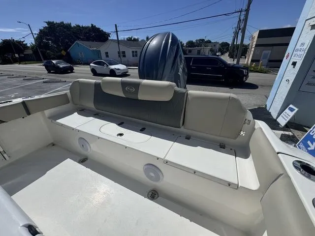 Slide: The Image of 2025 Key West 219 FS boat interior with seating and motor in urban setting. - 6