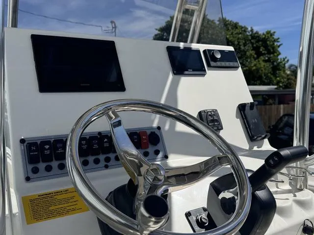 Slide: The Image of 2025 Key West 219 FS boat dashboard with steering wheel and control panel. - 8