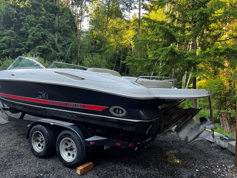 Slide: The Image of 2003 Monterey Montura boat on trailer, parked in a wooded area. - 11