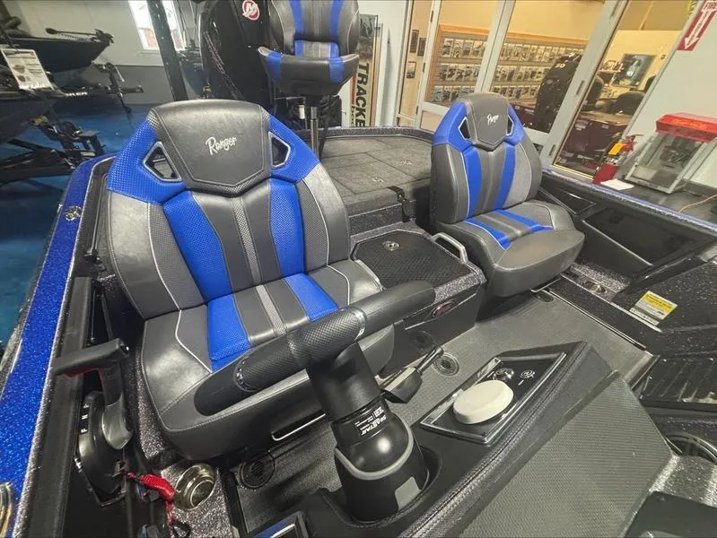 Slide: The Image of 2024 Ranger Z 521 R CUP ED boat interior with blue and gray seats. - 10