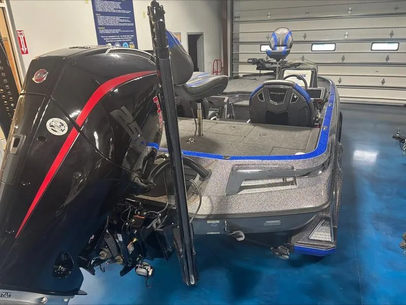 Slide: The Image of 2024 Ranger Z 521 R CUP ED boat in a garage, featuring a powerful outboard motor. - 5