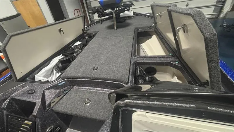 Slide: The Image of 2024 Ranger Z 521 R CUP ED boat interior with open storage compartments. - 6