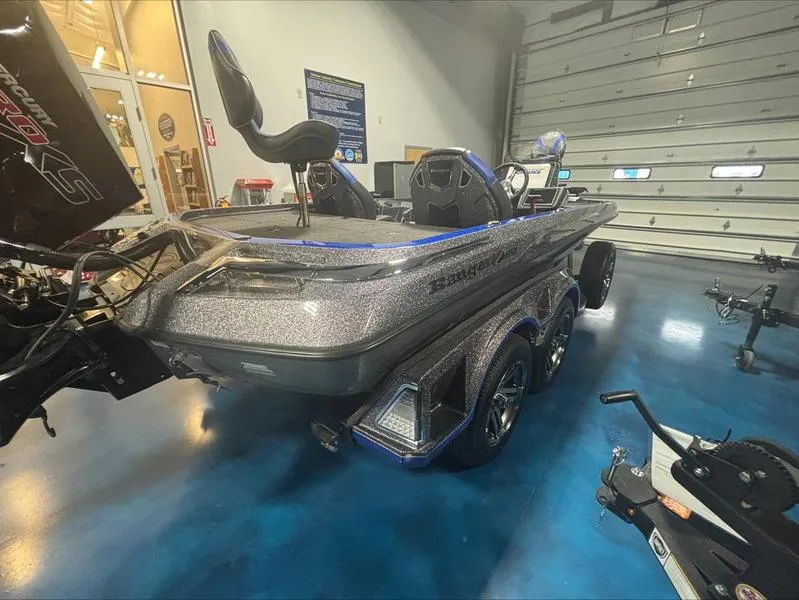 Slide: The Image of 2024 Ranger Z 521 R CUP ED boat in showroom, metallic finish, dual axle trailer. - 7