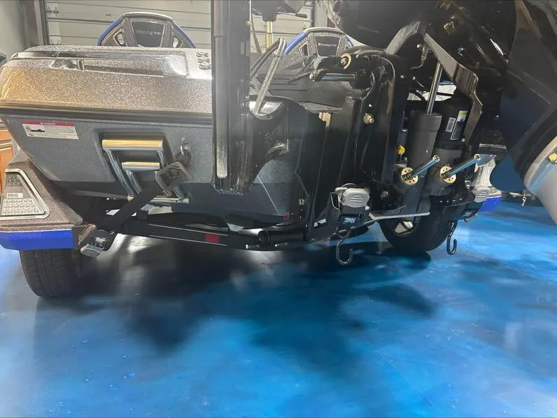 Slide: The Image of 2024 Ranger Z 521 R CUP ED boat on blue floor, showcasing rear components. - 9