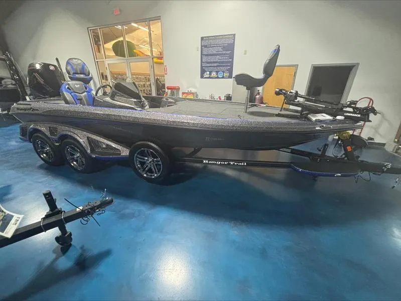 Slide: The Image of 2024 Ranger Z 521 R CUP ED boat in showroom, blue floor, sleek design. - 1