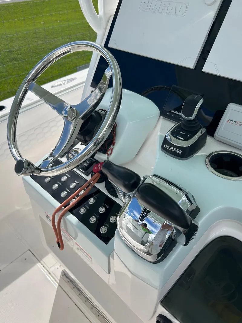 Slide: The Image of 2022 Stamas 33T Aventura boat helm with steering wheel and controls. - 5