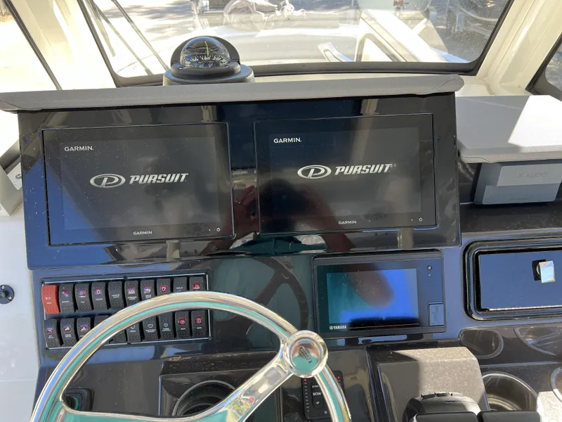 Slide: The Image of 2023 Pursuit S 288 boat dashboard with Garmin displays and Yamaha controls. - 11