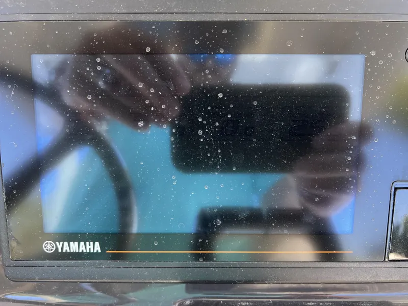 Slide: The Image of Yamaha display screen on 2023 Pursuit S 288 boat, showing reflections and water droplets. - 12