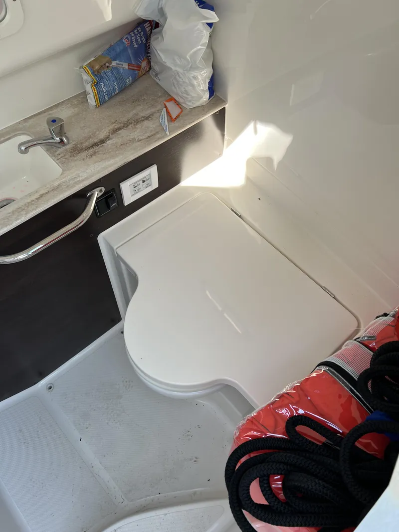 Slide: The Image of Interior of 2023 Pursuit S 288 boat with sink and storage area. - 17