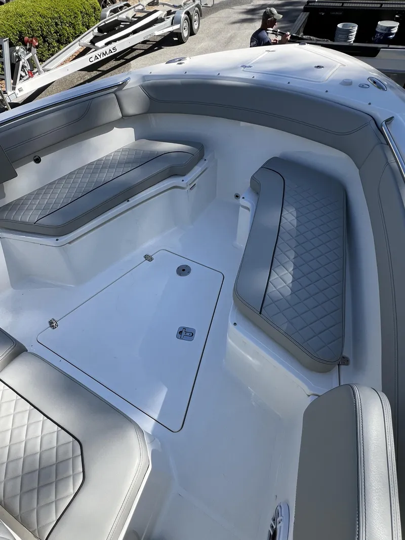 Slide: The Image of 2023 Pursuit S 288 boat interior with cushioned seating and storage compartments. - 19