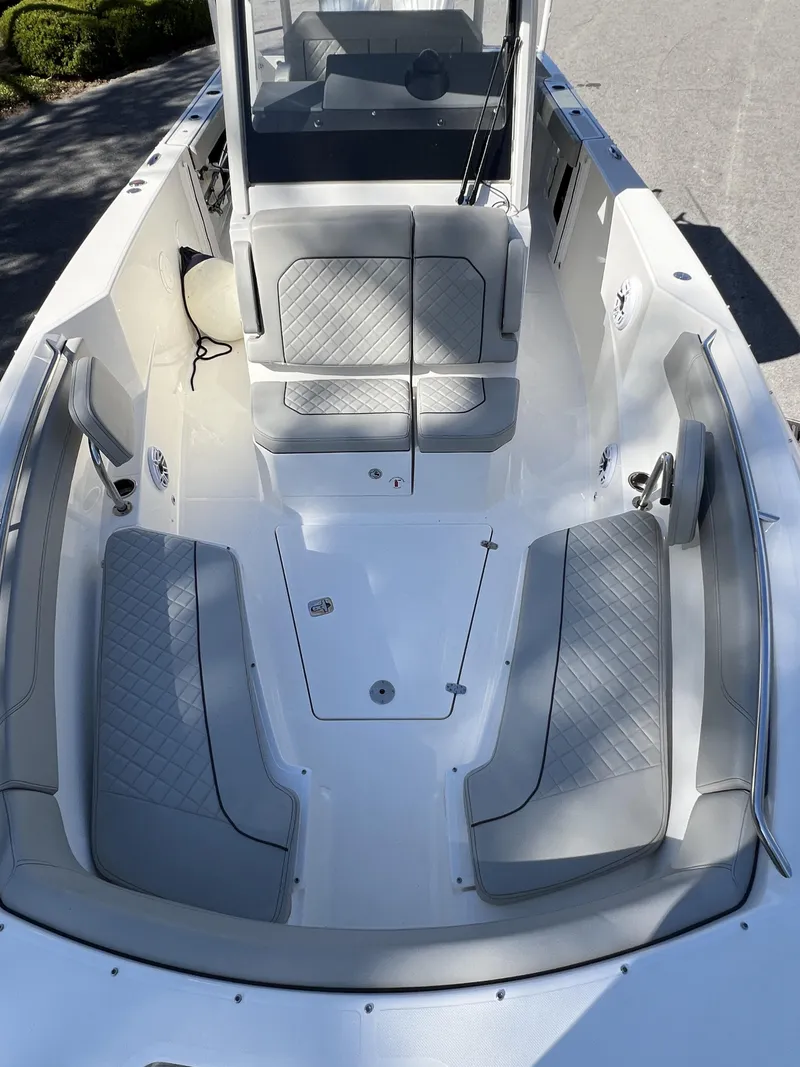 Slide: The Image of 2023 Pursuit S 288 boat interior with gray cushioned seating and sleek design. - 20